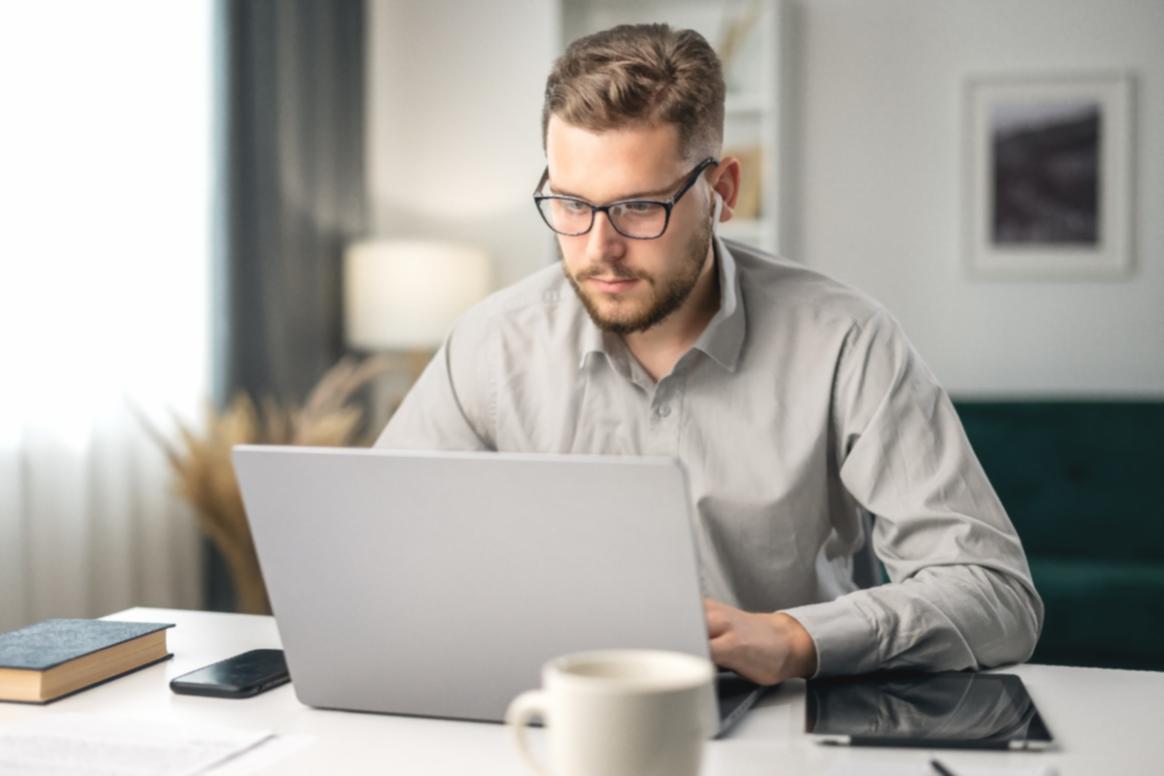 Professional working on sustainable tourism planning with local community maps and conservation documents
